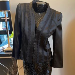 Women’s Escada black blazer with trimming along the front three hook buttons.